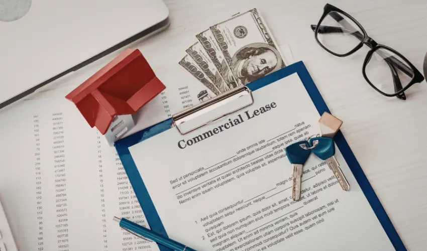 Commercial lease terms explained — solicitor reviewing commercial lease agreement with business tenant at desk