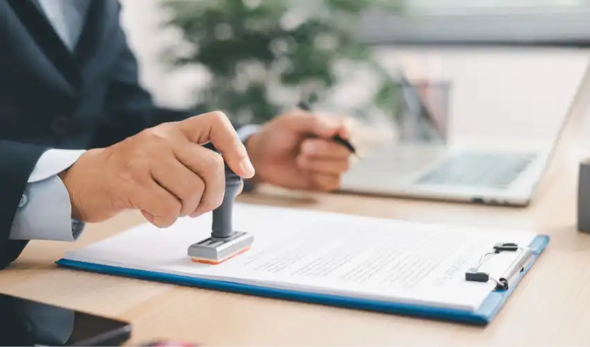Key clauses in a heads of terms agreement for a commercial lease shown on a desk alongside a pen and legal documents